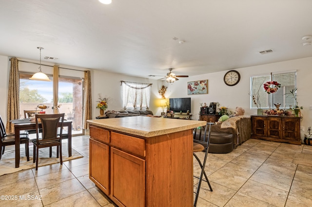 kitchen with open floor plan, visible vents, and light countertops