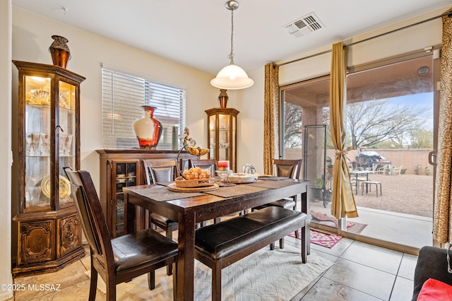 dining area with visible vents and light tile patterned flooring