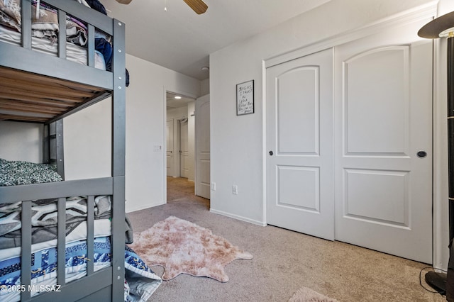 bedroom with carpet flooring, a closet, and a ceiling fan