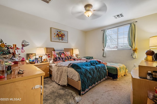 carpeted bedroom featuring ceiling fan and visible vents