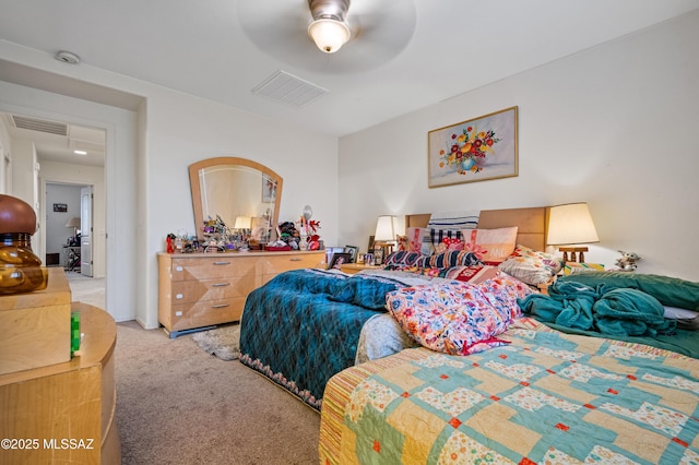 carpeted bedroom featuring visible vents and a ceiling fan