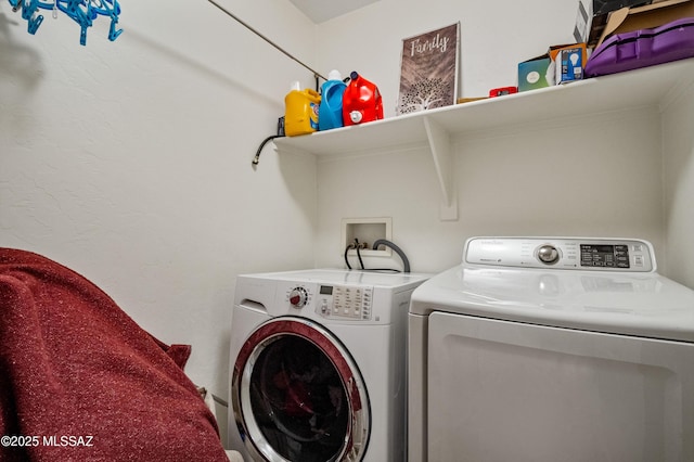 laundry area with separate washer and dryer and laundry area