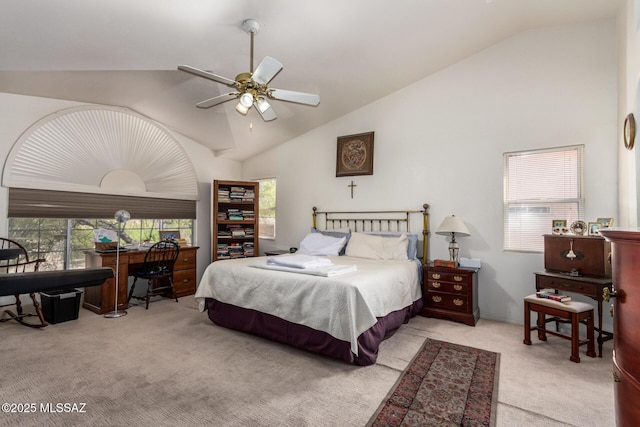 carpeted bedroom with ceiling fan and high vaulted ceiling