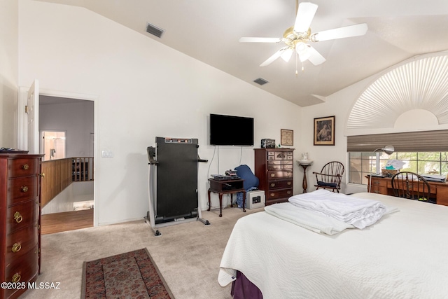 bedroom with light colored carpet, visible vents, and high vaulted ceiling
