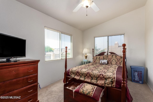 bedroom with ceiling fan, carpet flooring, and lofted ceiling