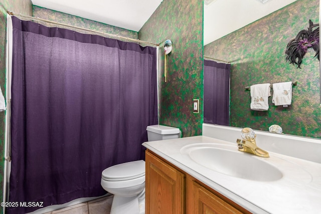 bathroom with vanity, tile patterned floors, toilet, and wallpapered walls
