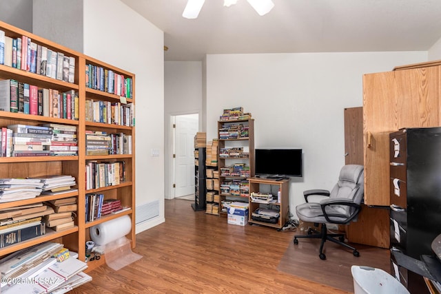 office space with visible vents, ceiling fan, and wood finished floors