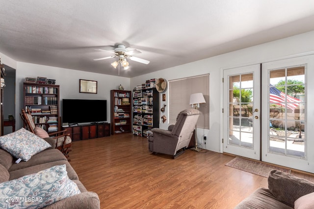 living room featuring french doors, a ceiling fan, and wood finished floors