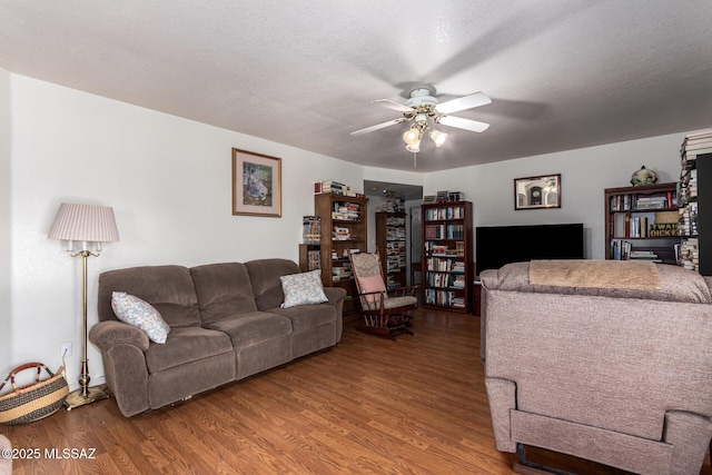 living area featuring ceiling fan and wood finished floors