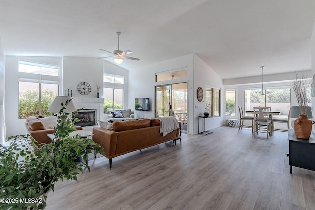 36526 S Wind Crest Dr, Tucson, AZ 85739 - living room with a ceiling fan, high vaulted ceiling, a glass covered fireplace, and light wood-type flooring
