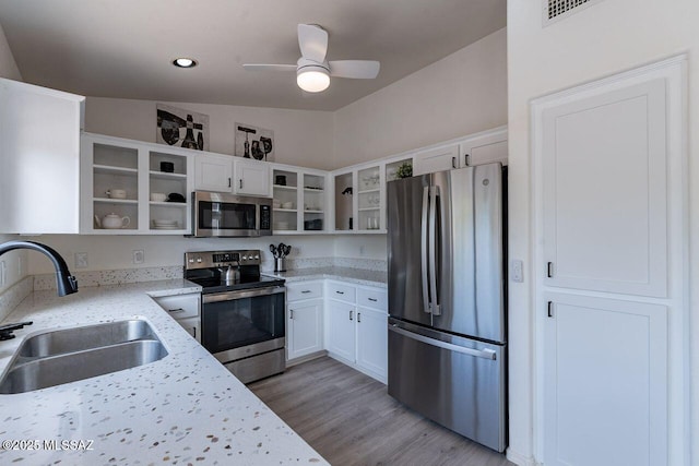 36526 S Wind Crest Dr, Tucson, AZ 85739 - kitchen featuring white cabinetry, a sink, open shelves, and appliances with stainless steel finishes