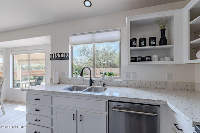 36526 S Wind Crest Dr, Tucson, AZ 85739 - kitchen with a sink, white cabinetry, light stone countertops, stainless steel dishwasher, and glass insert cabinets