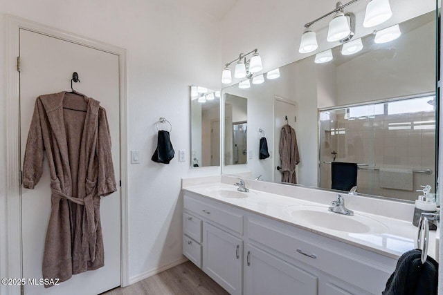 36526 S Wind Crest Dr, Tucson, AZ 85739 - bathroom featuring double vanity, a sink, wood finished floors, and a shower stall