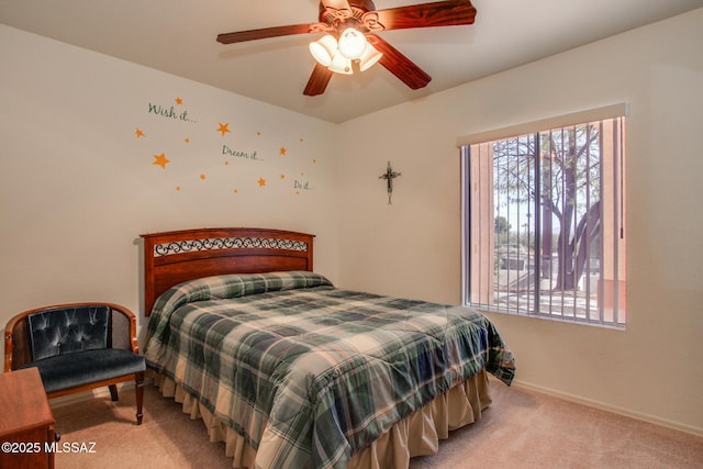 carpeted bedroom with baseboards and ceiling fan