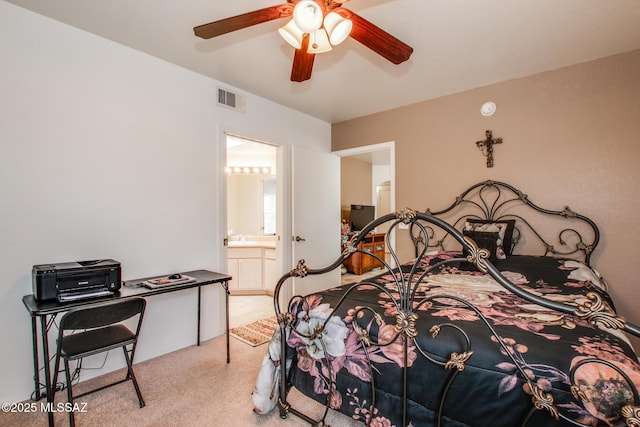 bedroom with light carpet, visible vents, ceiling fan, and ensuite bath