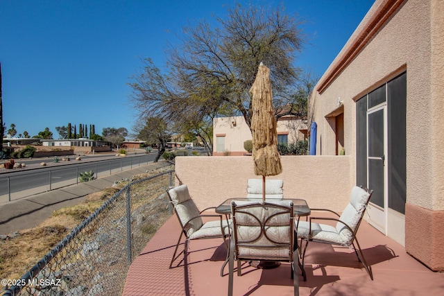 view of patio / terrace with outdoor dining area and fence
