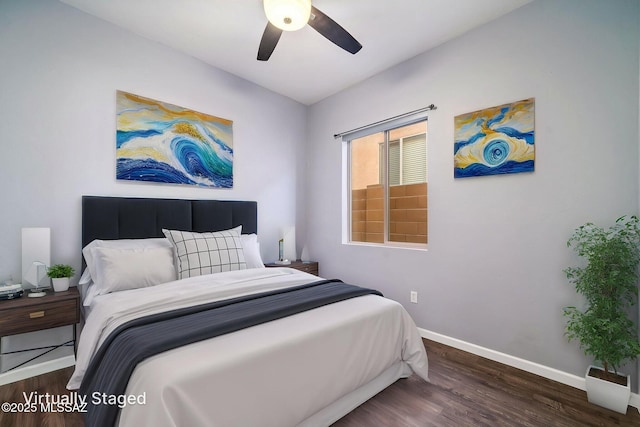 bedroom featuring baseboards, a ceiling fan, and wood finished floors