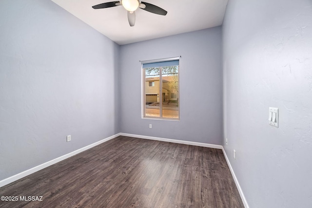 unfurnished room with dark wood finished floors, baseboards, and ceiling fan