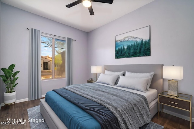 bedroom featuring baseboards, wood finished floors, and ceiling fan