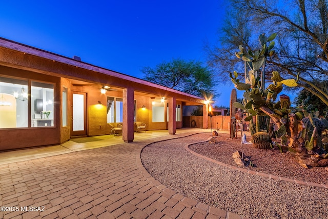 view of yard featuring a patio area, ceiling fan, and fence
