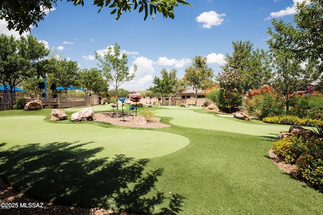 view of property's community with golf course view and fence
