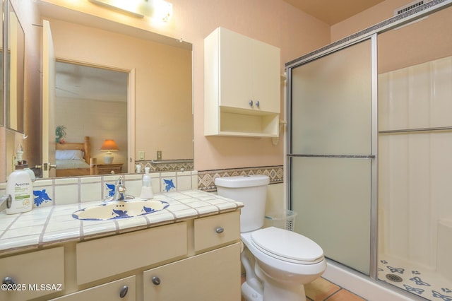 full bath with a shower stall, toilet, tile patterned flooring, and vanity