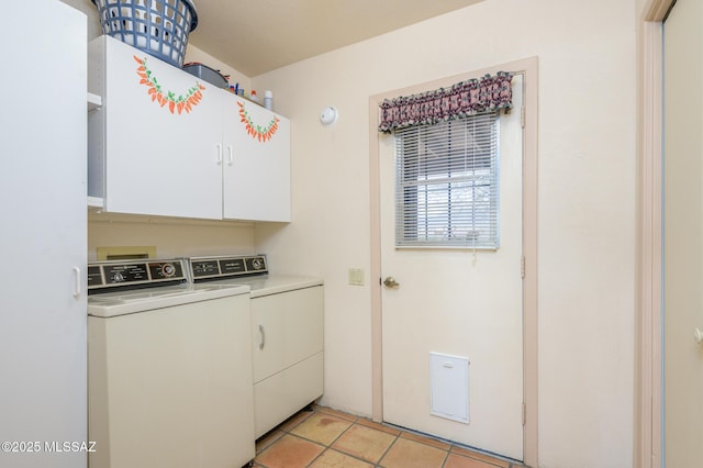 laundry room with light tile patterned floors, cabinet space, and washing machine and dryer