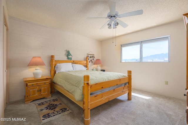 bedroom with carpet, ceiling fan, and a textured ceiling