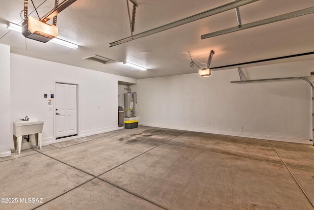 garage featuring water heater, baseboards, and a garage door opener