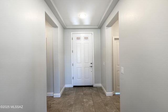 doorway to outside with baseboards