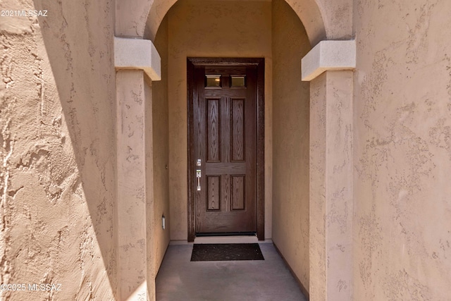 entrance to property featuring stucco siding