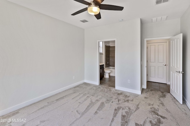 unfurnished bedroom featuring baseboards, light colored carpet, and visible vents