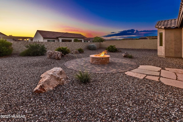 view of yard with a patio, a fenced backyard, and an outdoor fire pit