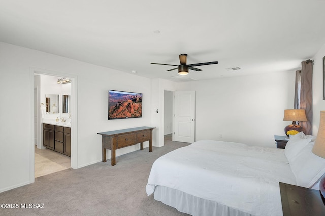 14239 E Axle Dr, Vail, AZ 85641 - bedroom with light colored carpet, baseboards, ceiling fan, and ensuite bath