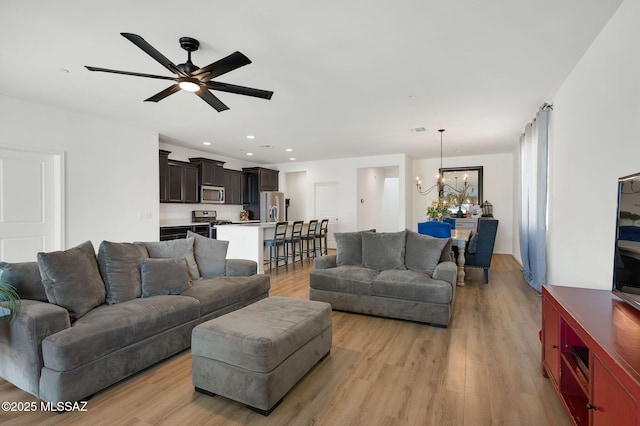 14239 E Axle Dr, Vail, AZ 85641 - living room featuring a chandelier, light wood finished floors, ceiling fan, and recessed lighting