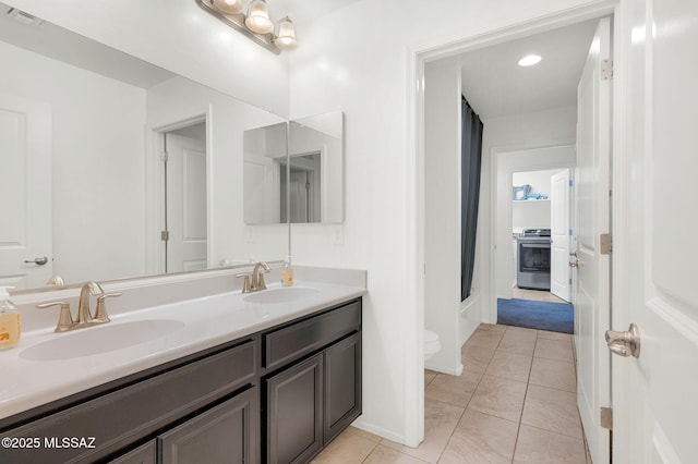 14239 E Axle Dr, Vail, AZ 85641 - bathroom with toilet, double vanity, tile patterned floors, and baseboards