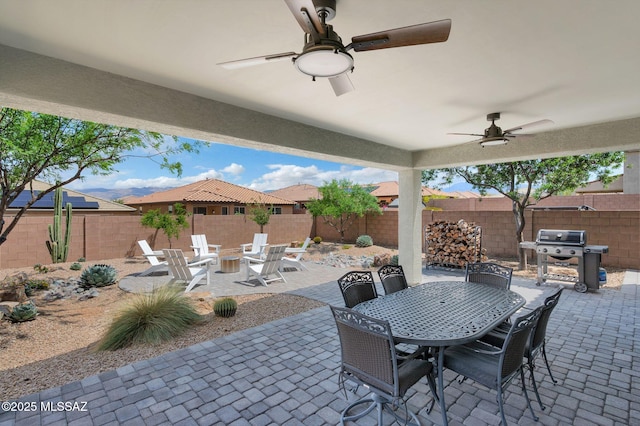 14239 E Axle Dr, Vail, AZ 85641 - fenced backyard with outdoor dining area, a patio, a grill, and a ceiling fan