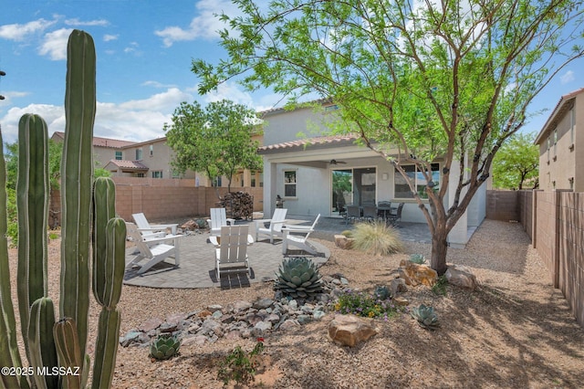 14239 E Axle Dr, Vail, AZ 85641 - rear view of property with ceiling fan, a patio area, a fenced backyard, a fire pit, and stucco siding