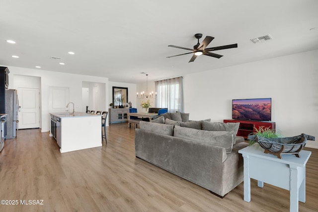14239 E Axle Dr, Vail, AZ 85641 - living area with a chandelier, light wood finished floors, ceiling fan, and recessed lighting