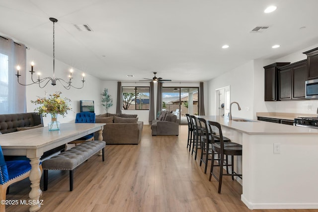 14239 E Axle Dr, Vail, AZ 85641 - dining space with light wood-type flooring, a chandelier, a ceiling fan, and recessed lighting