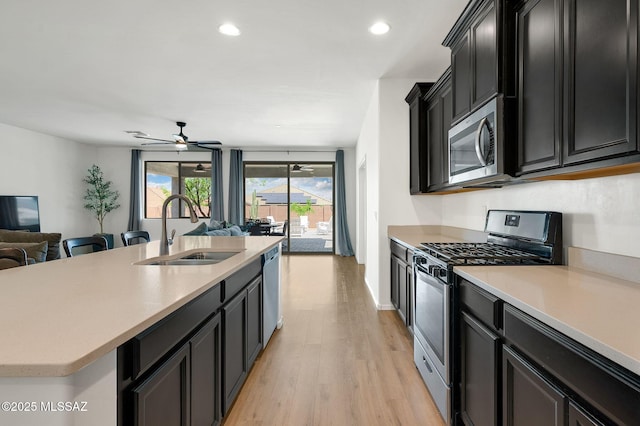 14239 E Axle Dr, Vail, AZ 85641 - kitchen with a sink, stainless steel appliances, open floor plan, dark cabinets, and recessed lighting
