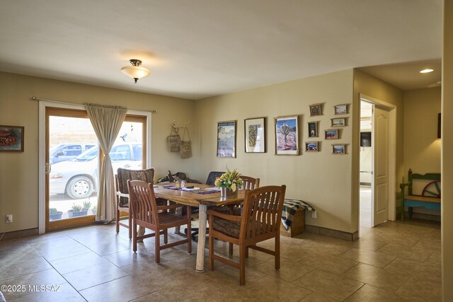 dining room featuring baseboards and tile patterned floors