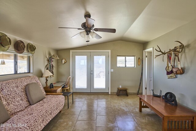living room featuring tile patterned floors, lofted ceiling, french doors, and a ceiling fan