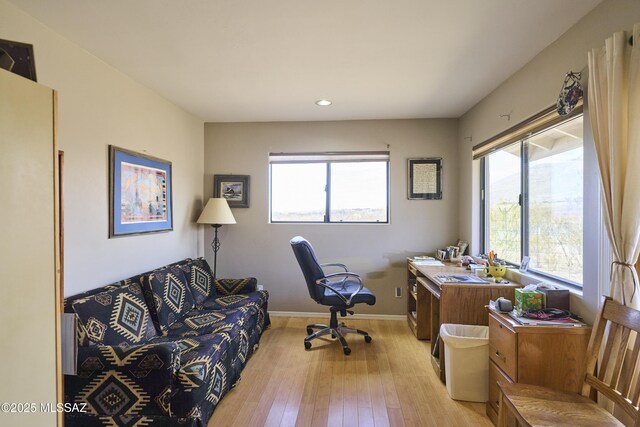 office featuring baseboards, light wood-style floors, and recessed lighting
