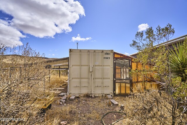 view of greenhouse with fence
