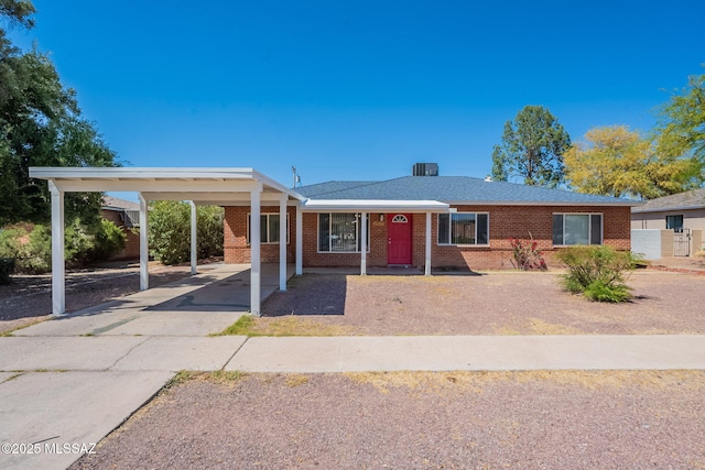 6517 E Cooper St, Tucson, AZ 85710 - ranch-style house with brick siding, concrete driveway, and an attached carport