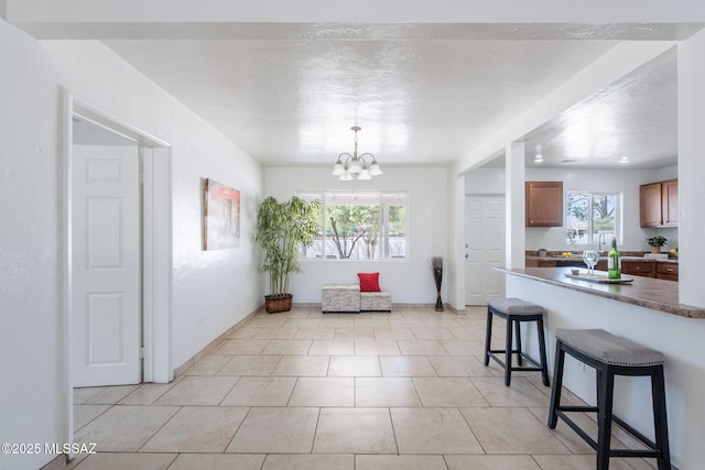 6517 E Cooper St, Tucson, AZ 85710 - dining area featuring a chandelier, baseboards, and light tile patterned floors