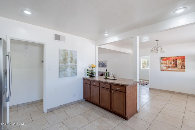 6517 E Cooper St, Tucson, AZ 85710 - kitchen featuring stainless steel fridge, a peninsula, a chandelier, recessed lighting, and baseboards