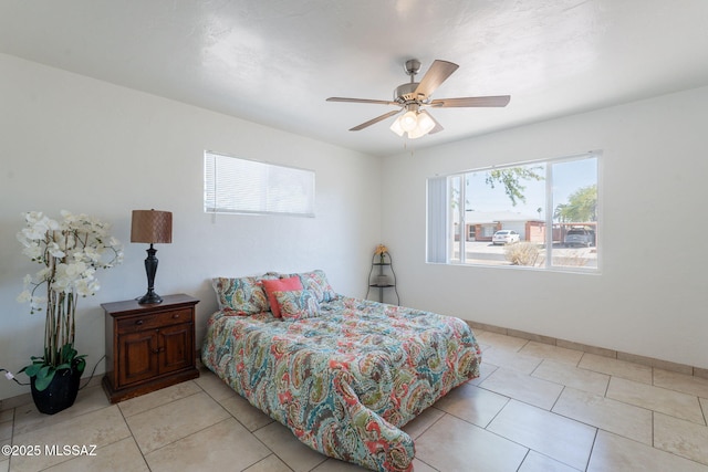 6517 E Cooper St, Tucson, AZ 85710 - bedroom featuring light tile patterned floors, ceiling fan, and baseboards