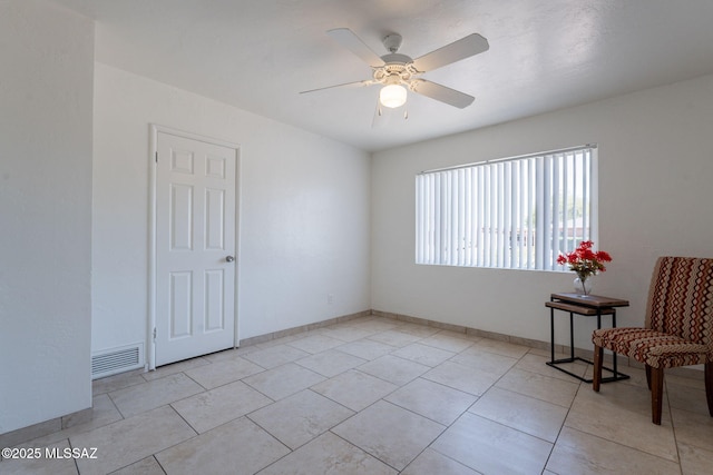 6517 E Cooper St, Tucson, AZ 85710 - unfurnished room with ceiling fan, light tile patterned floors, and baseboards